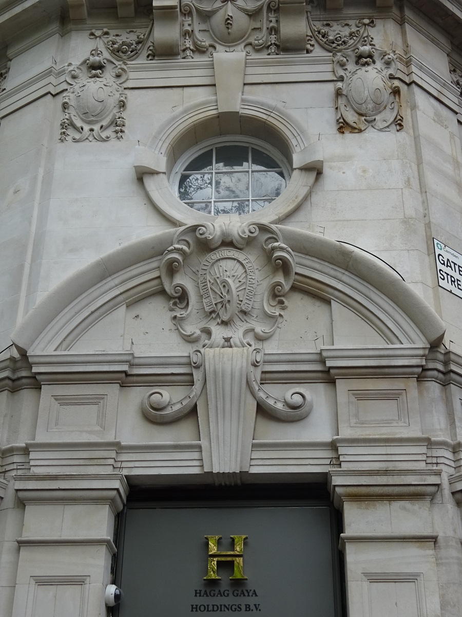 88 Kingsway, WC2. Magnet of tram rail, surrounding tram wheel above doorway, with legend 'British Electrical Federation Ltd'
