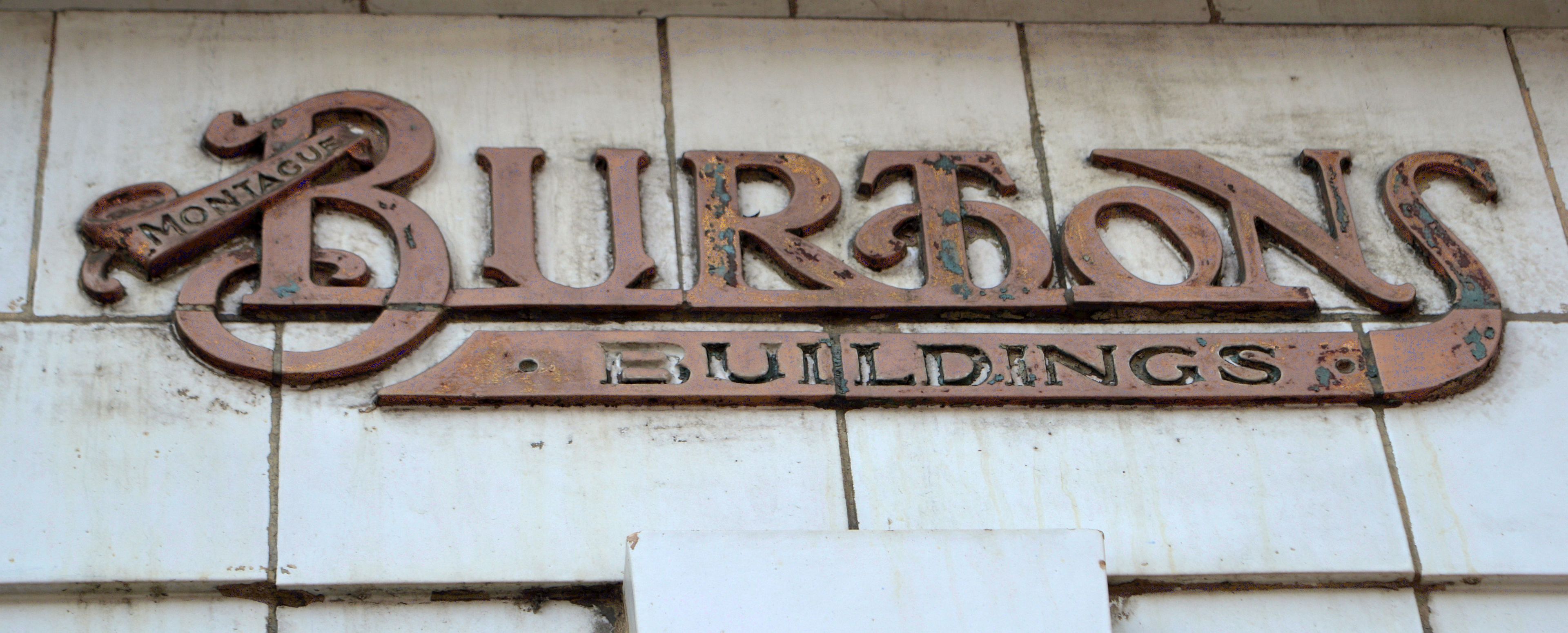Perhaps uniquely, 'Burton Buildings' sign above the side door to 100 High St North
